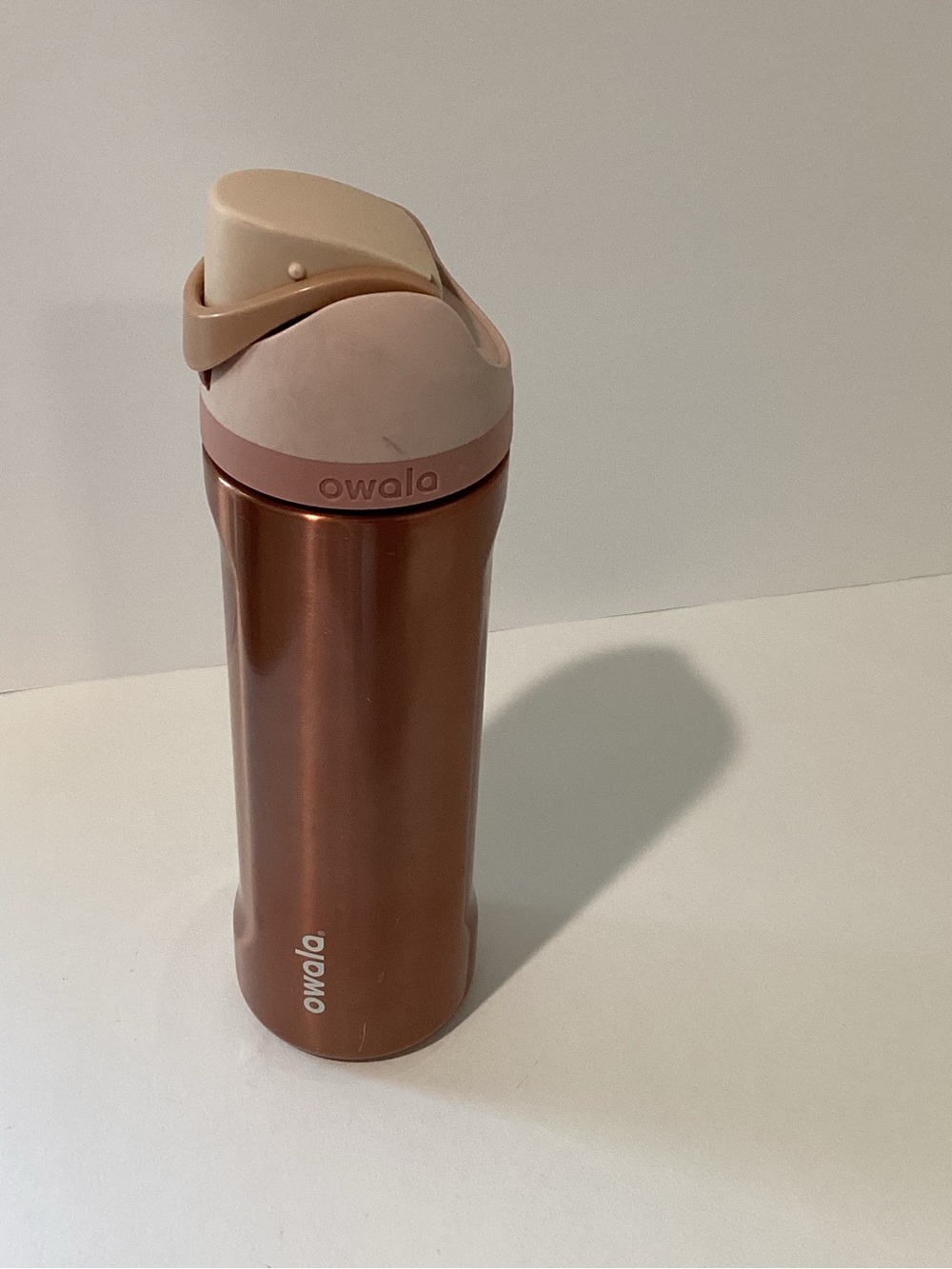 Owala Insulated Water Bottle in Rose Copper with Blush Pink Lid